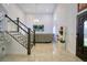 Bright living room with a staircase, chandelier, and large TV at 711 Cypress Ave, Orange City, FL 32763