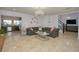 Spacious living room featuring a sectional sofa, coffee table, and chandelier at 711 Cypress Ave, Orange City, FL 32763