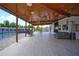 Large covered patio with pool, seating, and a ceiling fan at 711 Cypress Ave, Orange City, FL 32763