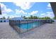 Inviting swimming pool with safety fence and paver deck at 711 Cypress Ave, Orange City, FL 32763