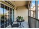 Cozy balcony featuring a table and chairs, perfect for relaxing outdoors at 8020 Tuscany Way # 6401, Davenport, FL 33896