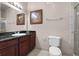 Bathroom with a dark wood vanity, granite countertop, framed mirror, and tiled walk-in shower at 8020 Tuscany Way # 6401, Davenport, FL 33896