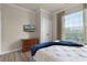 Bright bedroom with a queen-size bed, wood floors, and plenty of natural light at 8020 Tuscany Way # 6401, Davenport, FL 33896