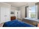 Inviting bedroom showcasing two beds, a window with blinds, and a mounted television at 8020 Tuscany Way # 6401, Davenport, FL 33896
