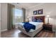 Cozy bedroom featuring a comfortable bed, two side tables, and a large window at 8020 Tuscany Way # 6401, Davenport, FL 33896
