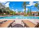 Resort-style pool with lounge chairs and palm trees offering a relaxing oasis at 8020 Tuscany Way # 6401, Davenport, FL 33896