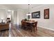 Dining area featuring a wooden table and chairs, with views to living room and bedroom at 8020 Tuscany Way # 6401, Davenport, FL 33896