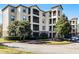 Apartment building with attractive landscaping and parking at 8020 Tuscany Way # 6401, Davenport, FL 33896