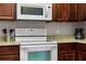 White appliances and granite countertop in kitchen at 8020 Tuscany Way # 6401, Davenport, FL 33896