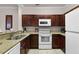 Well-equipped kitchen with granite countertops, stainless steel sink, and modern appliances at 8020 Tuscany Way # 6401, Davenport, FL 33896