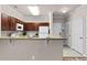 Efficient kitchen with wood cabinets, granite countertops, and a breakfast bar with seating at 8020 Tuscany Way # 6401, Davenport, FL 33896