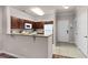 Bright kitchen features stainless appliances, including a range and microwave, and a breakfast bar at 8020 Tuscany Way # 6401, Davenport, FL 33896