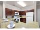 Kitchen with granite countertops and dark wood cabinets at 8020 Tuscany Way # 6401, Davenport, FL 33896
