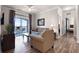 Living room features hardwood floors and access to a balcony at 8020 Tuscany Way # 6401, Davenport, FL 33896