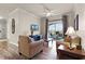 Bright living room with balcony access and hardwood floors at 8020 Tuscany Way # 6401, Davenport, FL 33896