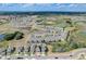 Aerial view of residential community featuring houses, a pool and a pond at 828 Scrub Oak Hammock Rd, Davenport, FL 33837