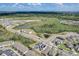 Aerial view of residential neighborhood with houses and pond at 828 Scrub Oak Hammock Rd, Davenport, FL 33837