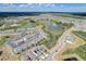 Aerial perspective of a residential area featuring houses and a pond at 828 Scrub Oak Hammock Rd, Davenport, FL 33837