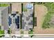 Aerial view of two homes with solar panels, a pool, and surrounding landscape at 828 Scrub Oak Hammock Rd, Davenport, FL 33837