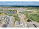 Aerial view of houses, a pond, and surrounding landscape at 828 Scrub Oak Hammock Rd, Davenport, FL 33837