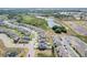 Aerial view of a residential community with houses, ponds, and green spaces at 828 Scrub Oak Hammock Rd, Davenport, FL 33837