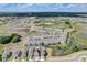Aerial view of a new home community with multiple houses, a pond, and lush green landscaping at 828 Scrub Oak Hammock Rd, Davenport, FL 33837