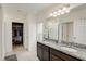 Double vanity bathroom with granite countertop and large mirror at 828 Scrub Oak Hammock Rd, Davenport, FL 33837