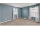 Bedroom with light blue walls, carpet, and two windows with curtains at 828 Scrub Oak Hammock Rd, Davenport, FL 33837