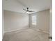 Primary bedroom with ceiling fan, carpet, and neutral walls at 828 Scrub Oak Hammock Rd, Davenport, FL 33837