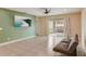 Living room with tile floors, green accent wall, and sliding glass doors at 828 Scrub Oak Hammock Rd, Davenport, FL 33837
