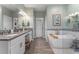 Elegant bathroom with double vanity, large soaking tub, and separate shower at 941 Orchard Charm Ct, Oviedo, FL 32765