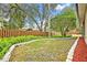 Landscaped backyard with a wooden fence and red mulch at 9446 Brownwood Ct, Oviedo, FL 32765