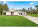 New construction home with a three-car garage and large front yard at Tbd Marion Oaks Ln, Ocala, FL 34473