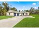 New construction home with a three-car garage and large front yard at Tbd Marion Oaks Ln, Ocala, FL 34473