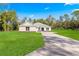 New construction home with a three-car garage and large front yard at Tbd Marion Oaks Ln, Ocala, FL 34473
