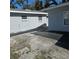 Wide shot of the backyard with partial stone walkways and two visible windows at 1026 Lake Jessamine Dr, Orlando, FL 32839