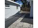 Wide shot of the backyard with partial stone walkways and two visible windows at 1026 Lake Jessamine Dr, Orlando, FL 32839