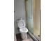 Bathroom featuring a toilet and shower with glass door at 1026 Lake Jessamine Dr, Orlando, FL 32839