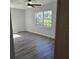 Bright bedroom featuring hard wood floors, ceiling fan and a window at 1026 Lake Jessamine Dr, Orlando, FL 32839