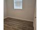 Bedroom featuring wood-look floors, neutral paint and a window at 1026 Lake Jessamine Dr, Orlando, FL 32839