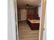 Bedroom with light colored wood floors, ceiling fan, wood walls and a large closet at 1026 Lake Jessamine Dr, Orlando, FL 32839