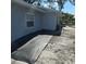 The side of the home features a window and a view of the outdoor area at 1026 Lake Jessamine Dr, Orlando, FL 32839