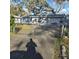 View of the gated front yard and an exterior view of the residence at 1026 Lake Jessamine Dr, Orlando, FL 32839