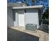 A bright exterior shot of the home's back with a door and modern AC unit at 1026 Lake Jessamine Dr, Orlando, FL 32839