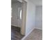 Hallway view featuring wood-look flooring, white trim and doors at 1026 Lake Jessamine Dr, Orlando, FL 32839
