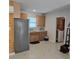 Bright kitchen featuring oak cabinets, stainless steel appliances, and epoxy flooring at 1026 Lake Jessamine Dr, Orlando, FL 32839