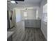 Open kitchen concept showcasing an island, stainless steel fridge, and wood-look flooring at 1026 Lake Jessamine Dr, Orlando, FL 32839