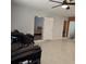 Open-concept living area with neutral walls, tiled flooring, and entry to the bathroom and bedroom at 1026 Lake Jessamine Dr, Orlando, FL 32839