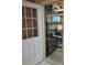 Basement storage area with secure metal door and convenient shelving at 1026 Lake Jessamine Dr, Orlando, FL 32839