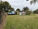 Large backyard with a shed and plenty of green space at 110 Country Club Cir, Sanford, FL 32771